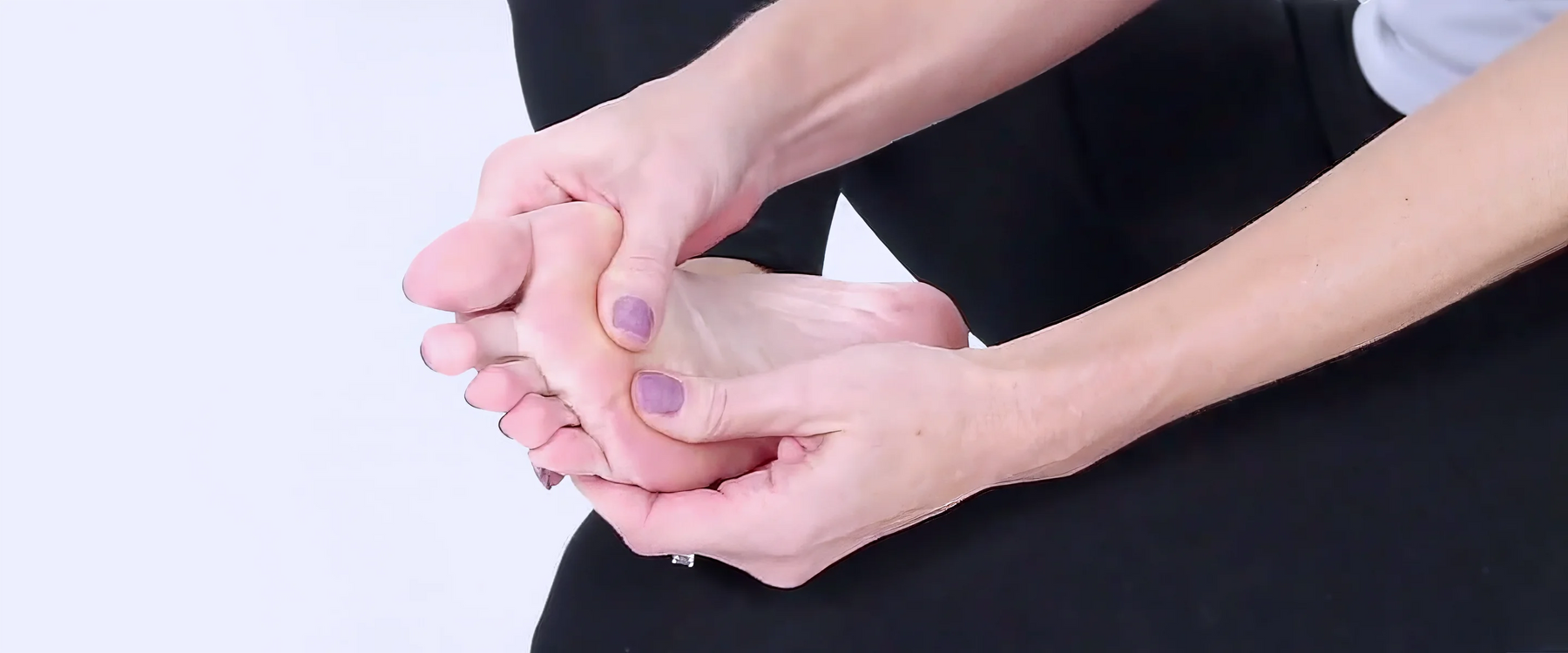 woman massaging foot