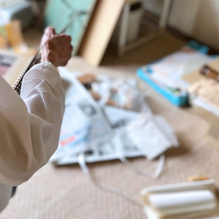 Elderly woman decluttering room