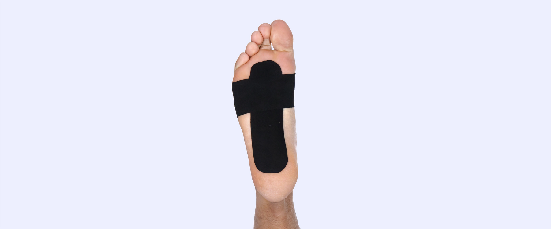 Foot with black tape on sole