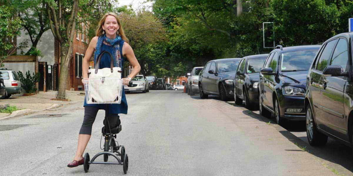 Happy woman using knee scooter