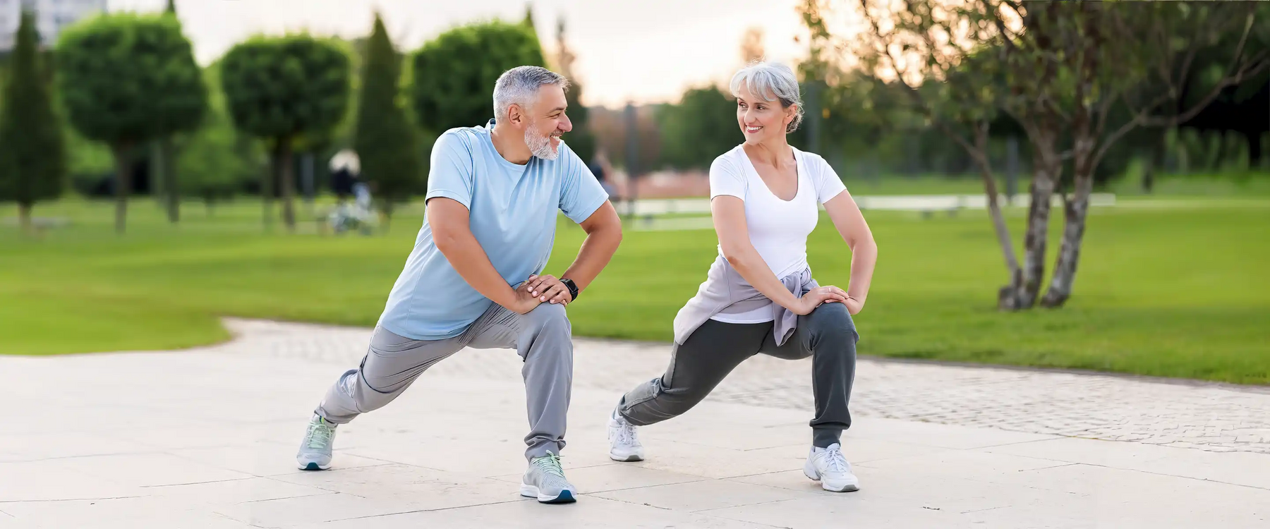 Joyful senior husband and wife making sport outdoors