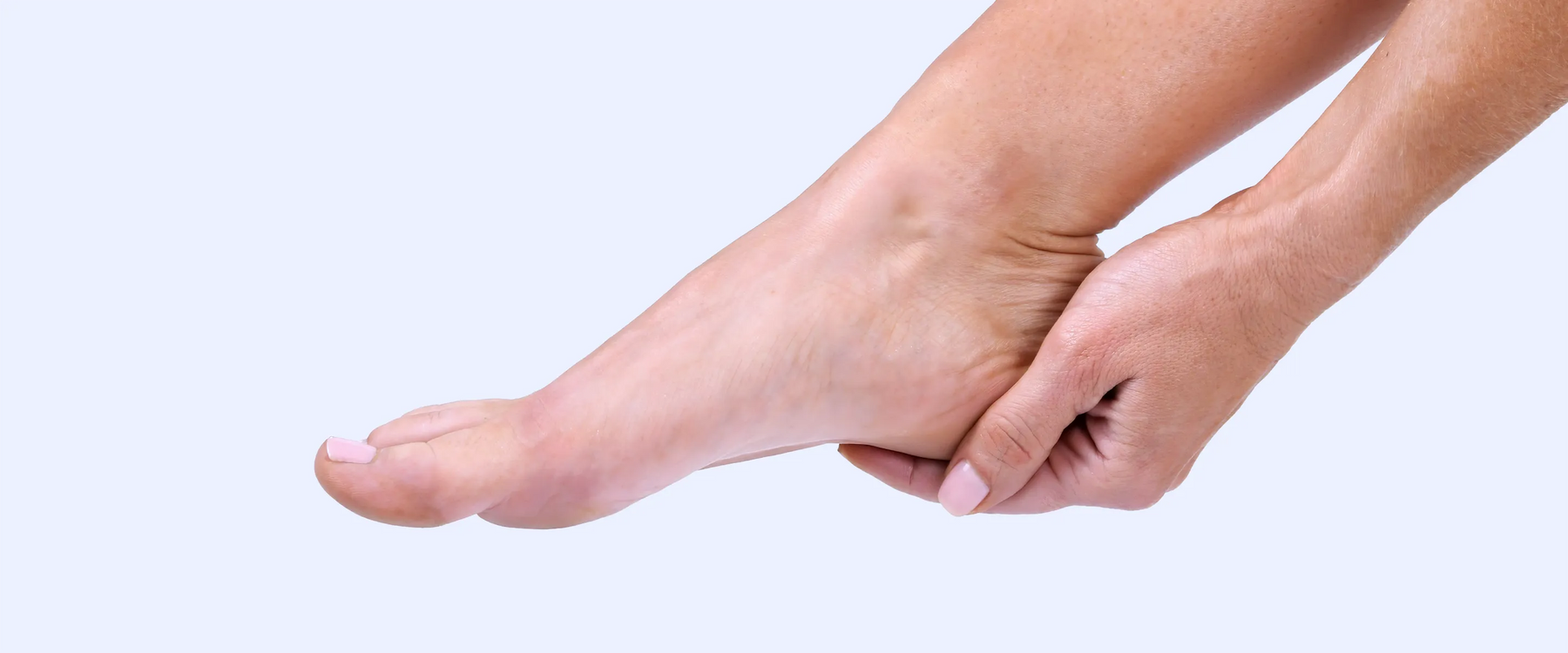 Left hand holding on the heel of the right foot