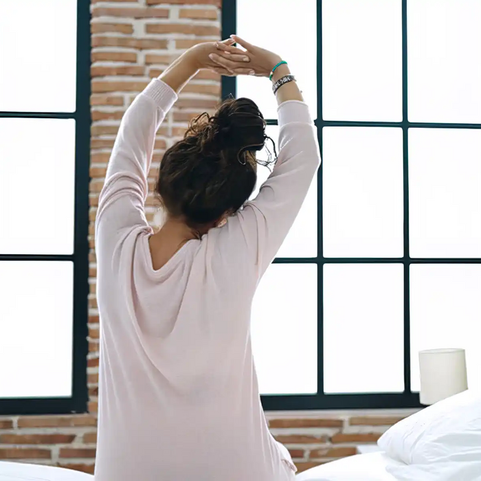 woman waking up stretching