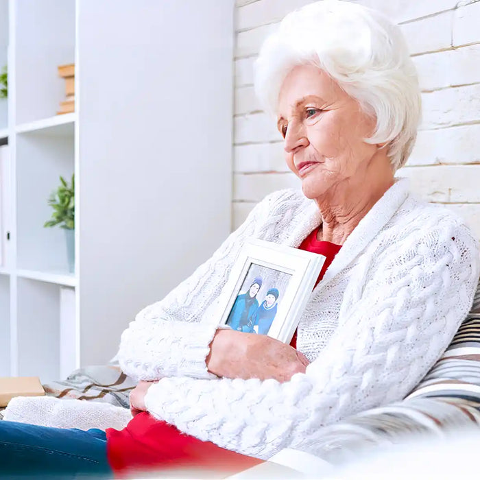 Senior woman sitting at home alone in armchair
