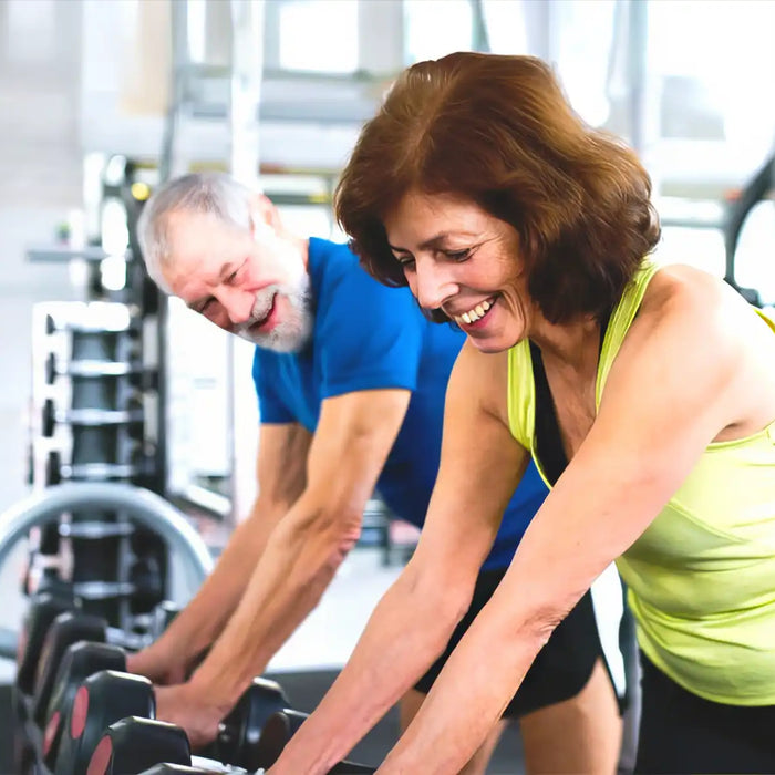 Senior couple in gym working out
