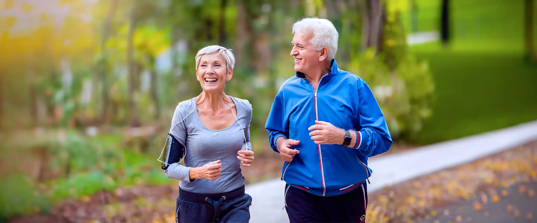 Smiling senior couple jogging in the park