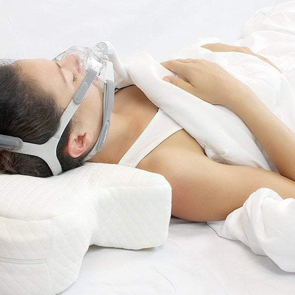 Woman sleeping with CPAP Mask