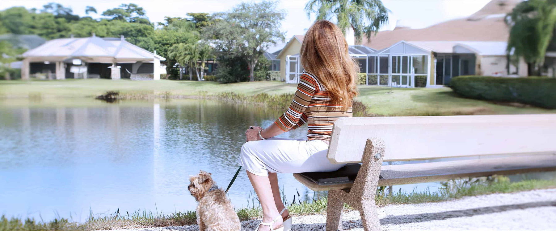 Woman sitting near a pond