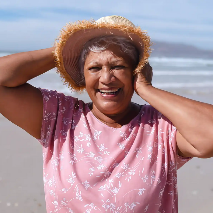 elderly woman on beach in sun