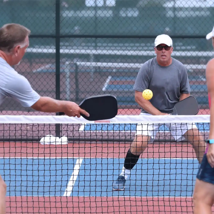 senior playing pickleball tournament